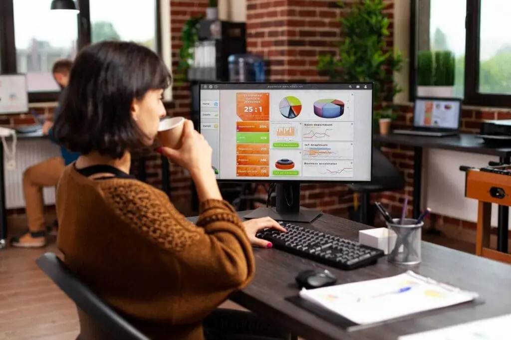 Girl working while sipping coffee