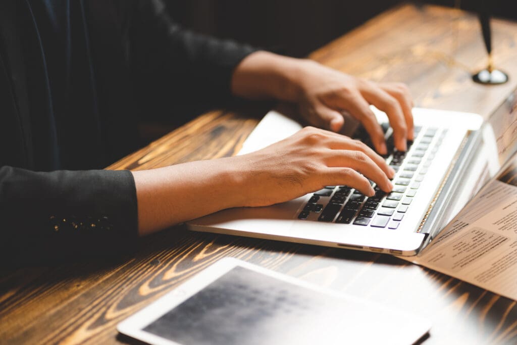 typing on computer laptop