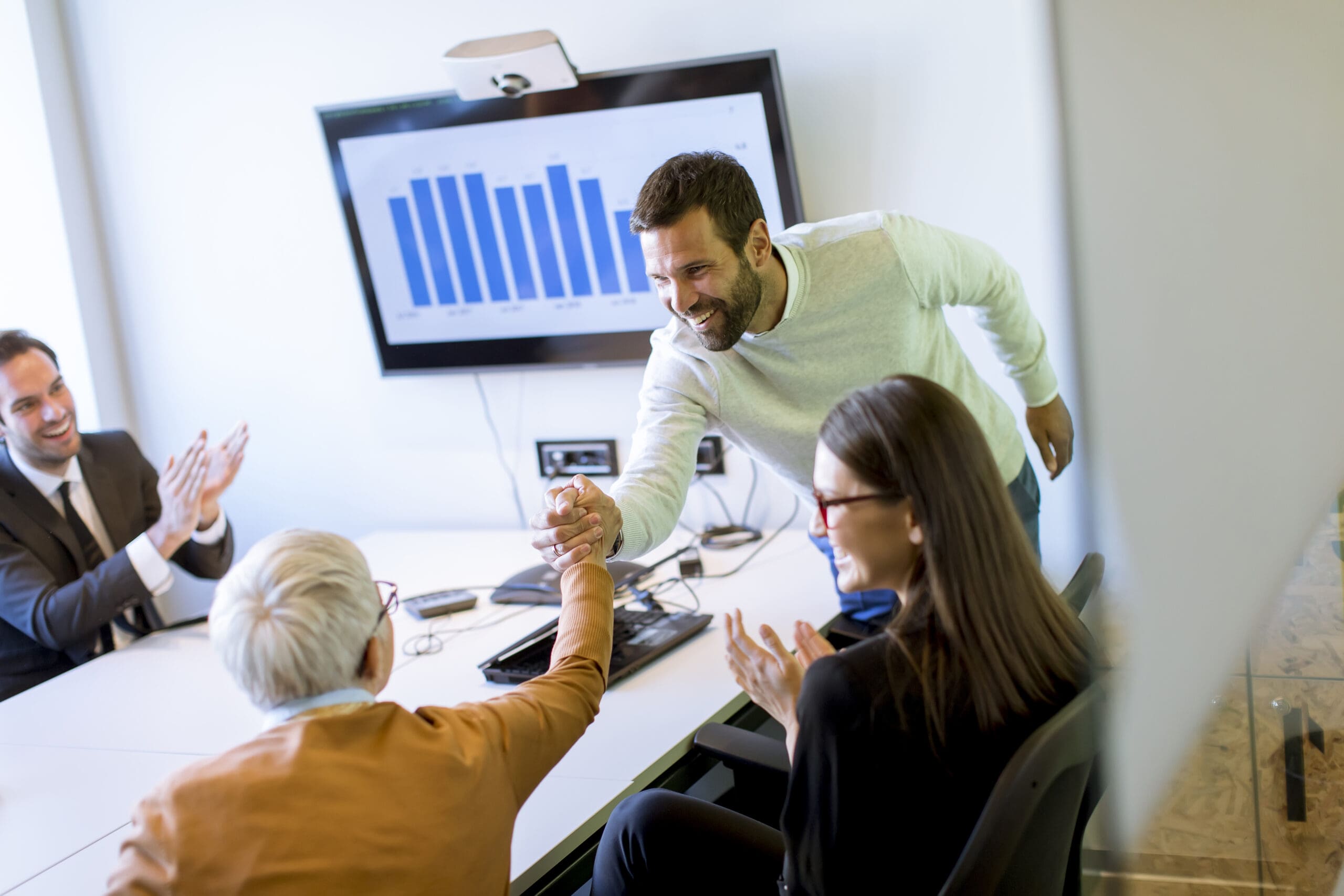 Businessman presenting project strategy showing ideas on interactive whiteboard in office
