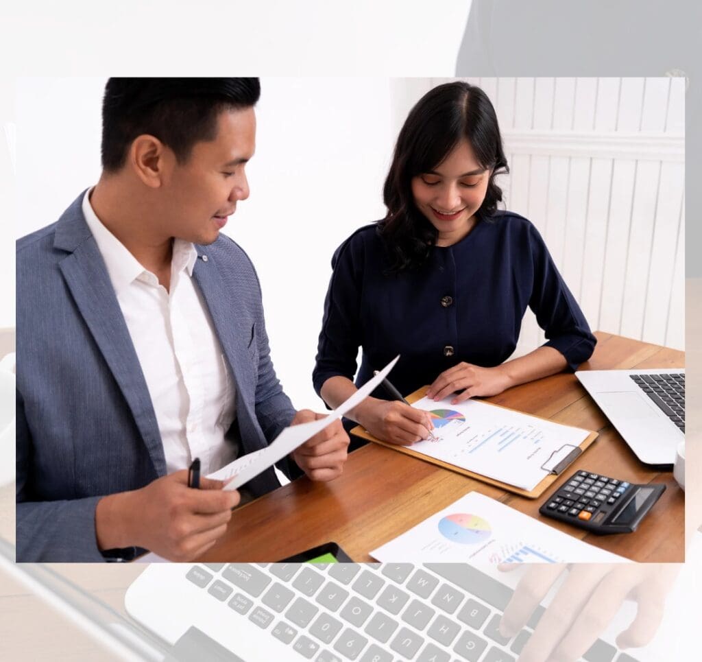 Business colleagues reviewing financial reports and charts at the office table.